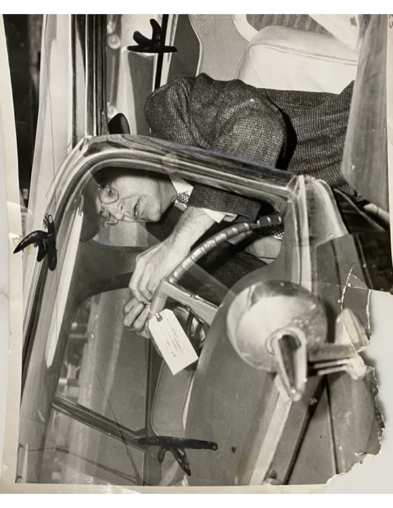 A photo of Fred's agent tagging a car that they seized during a raid